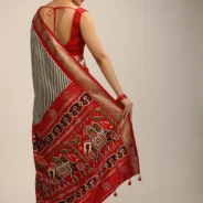 red_saree_in_silk_with_multi_colored_patola_print3.webp